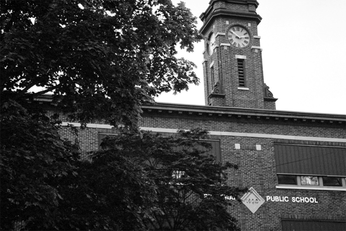 Photo of historic school building with bell tower.